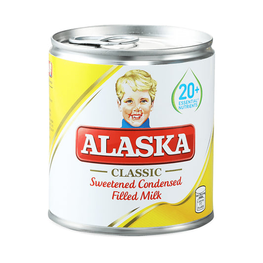 Can of Alaska Classic Sweetened Condensed Filled Milk with vintage design on a white background
