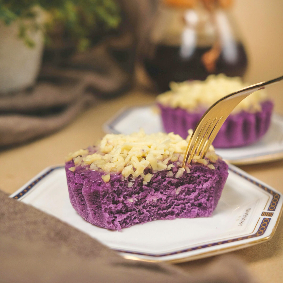 Ube (purple yam) dessert with cheese  topping on a plate with a fork, blurred background